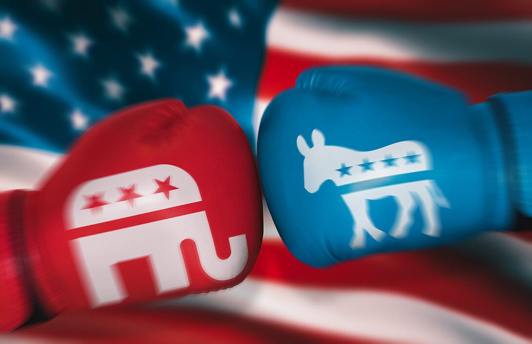 Two boxing gloves inscribed with political symbols is a metaphor for political battles.