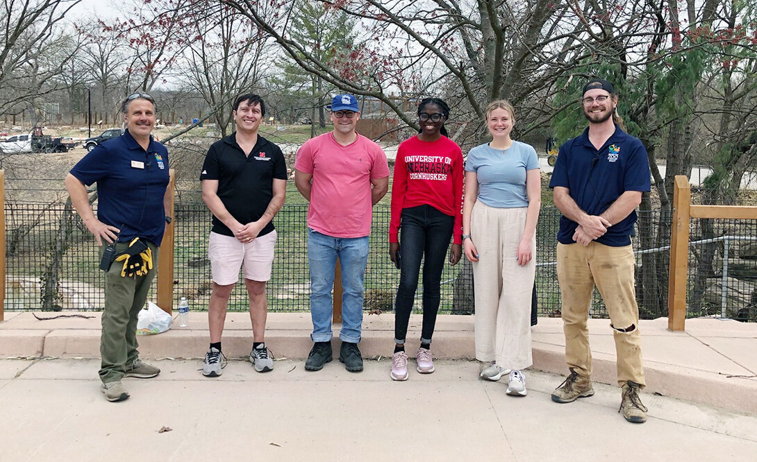 Andrew Brown (second from left), Ben Bentzinger, Promise Emmanuel and MaKenna Clinch take a photo with two Kansas City Zoo staff members.