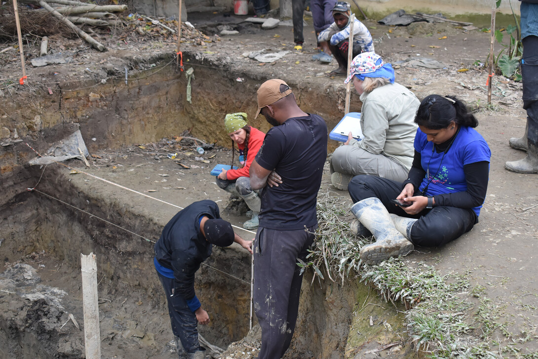 Members of an excavation team document where evidence was found.