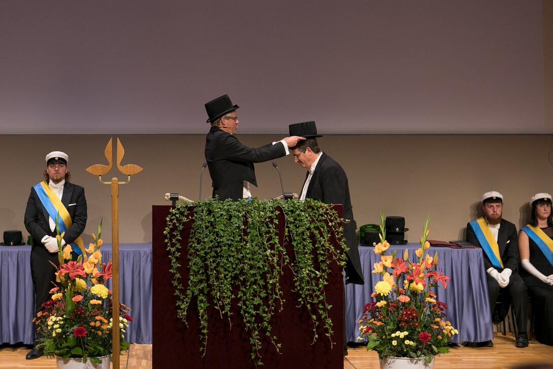 Cahoon receives doctoral hat during graduation ceremony.