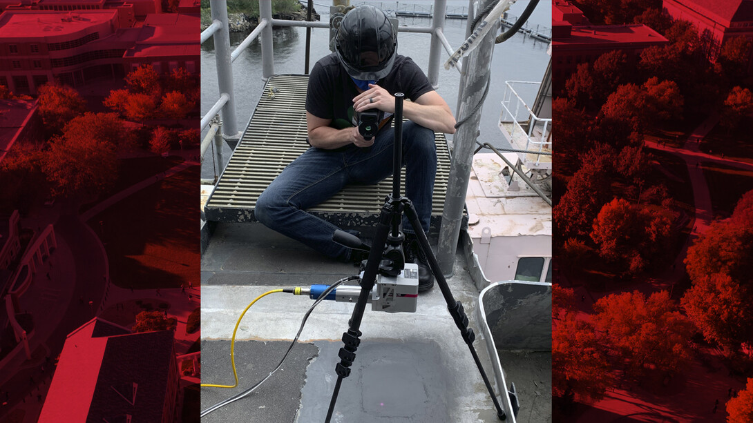 Tim Carlson watches as the Nebraska-developed laser system works on a patch of aluminum-alloy during the test about a ship in Norfolk, Virginia.