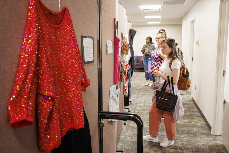 Graduate students Elyxcus Anaya and Jessica Boyles examine the "What Were You Wearing?" survivor art installation in April 2022. Photo by Craig Chandler, UCOMM.