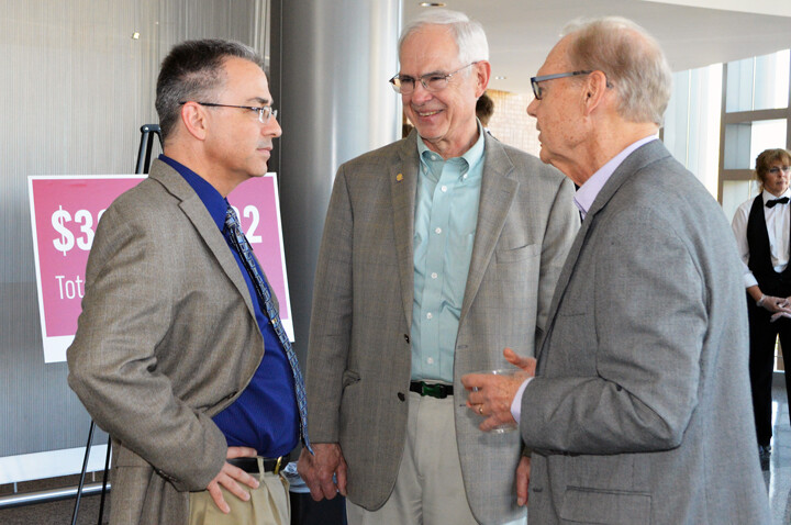 NDMC director Mike Hayes (left) and NDMC founder Don Wilhite (right) talk with Sen. Ken Haar during the center's 20th anniversary celebration on Friday at the International Quilt Study Center and Museum.