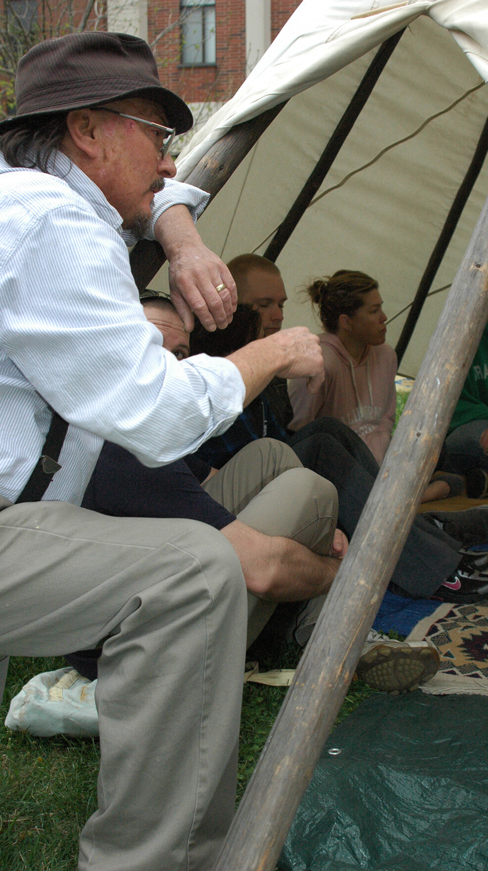 Mark Awakuni-Swetland (left) talks with students after the completion of a tipi set up outside of UNL's Oldfather Hall in April 2012.