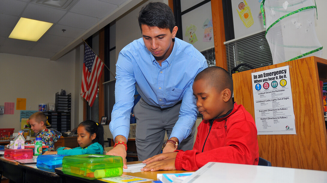 UNL's Emanuel "Manny" Maldonado assists an Everett Elementary student with a math lesson on Sept. 10. Maldonado has worked at Everett for three years as a participant in America Reads, America Counts, a federal work-study program.