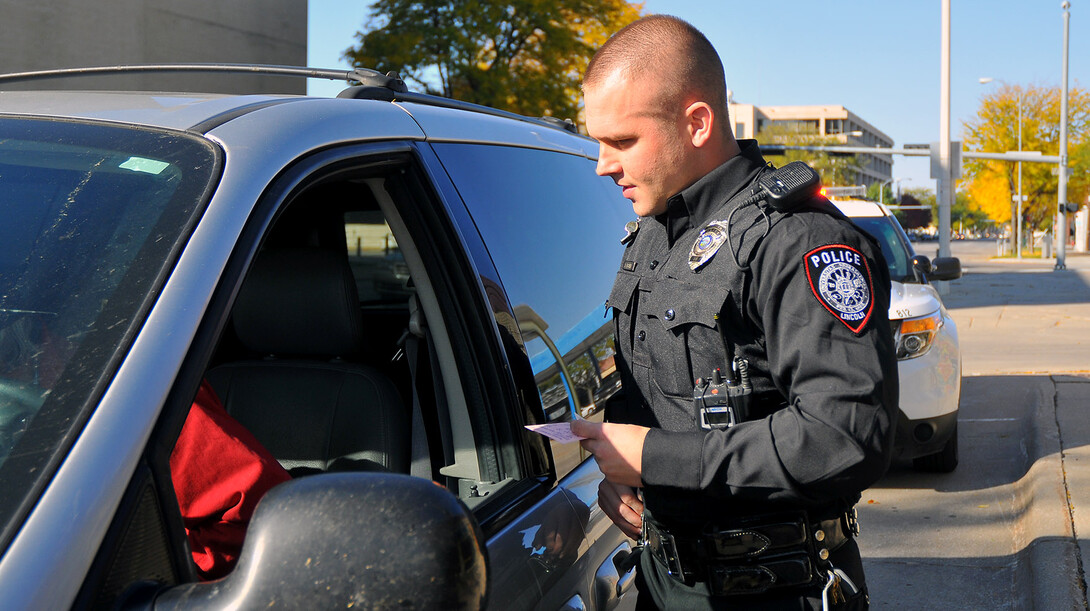 Officer Eric Fischer talks with a driver during a routine traffic stop. The UNL Police Department has received accreditation after a three-year review by the Commission  on Accreditation for Law Enforcement Agencies.