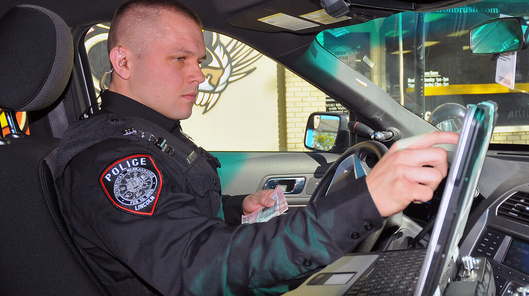 Officer Eric Fischer accesses a driver's information during a stop on Oct. 17. The UNL Police Department is seeking accreditation from the Commission on Accreditation for Law Enforcement Agencies. A final onsite review begins Nov. 9.