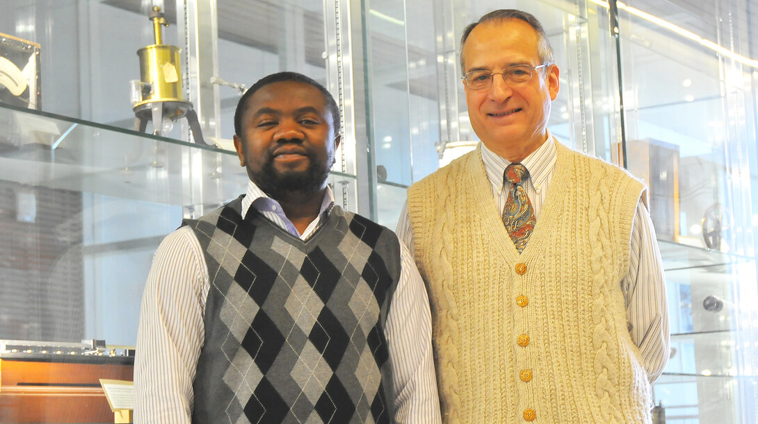 Jean Marcel Ngoko Djiokap (left) and Anthony Starace are co-authors on a study that identified the characteristics of a laser pulse that yields electron behavior they can predict and control.