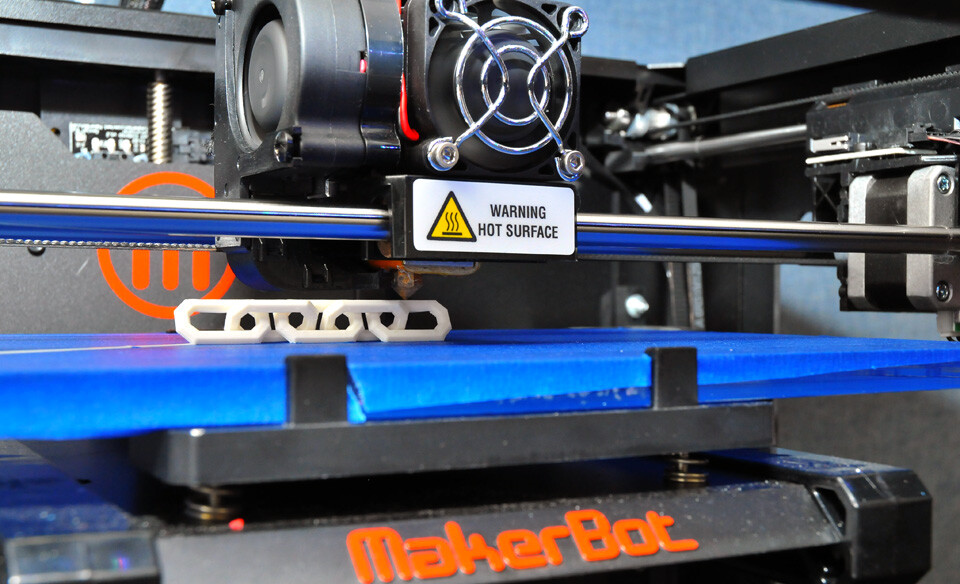 Print Services’ MakerBot Replicator 2 printer creates a five-link chain by building up paper-thin layers of a melted, corn based plastic.