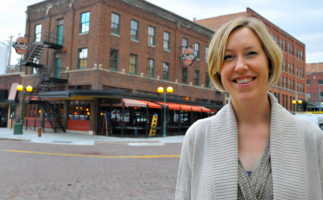 Jenny Dauer, assistant professor of practice, stands across the street from Lazlo's in the Haymarket. The buliding — along with others around Lincoln — was designed and built by Dauer's great-great-grandfather, John G. Cordner. The building was originally called the Bennett Hotel.