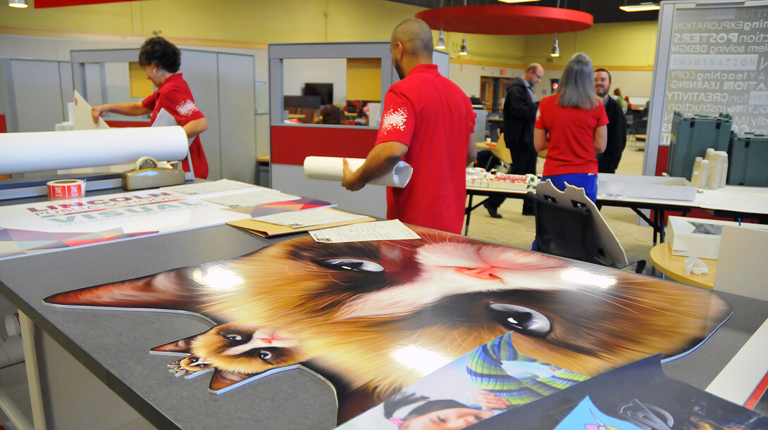 Grumpy Cat looks on as Pixel Lab employees work on projects during the March 17 open house in Henzlik Hall. The lab, formerly known as the Instructional Design Center, has offered creative services for decades to UNL students, faculty and staff.