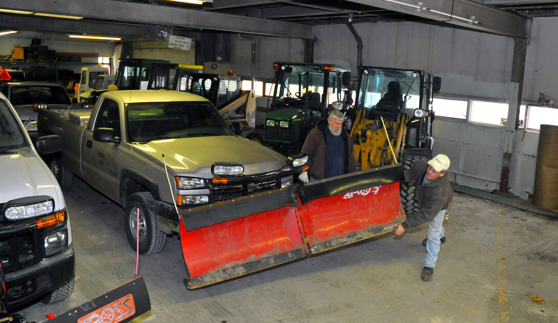 Landscape Services employees (from right) Kirby Baird and Dale Schmidt check snow blade as part of prep work for a forecasted snow storm. The Feb. 4 storm is projected to drop between two and 10 inches of snow in Lincoln.