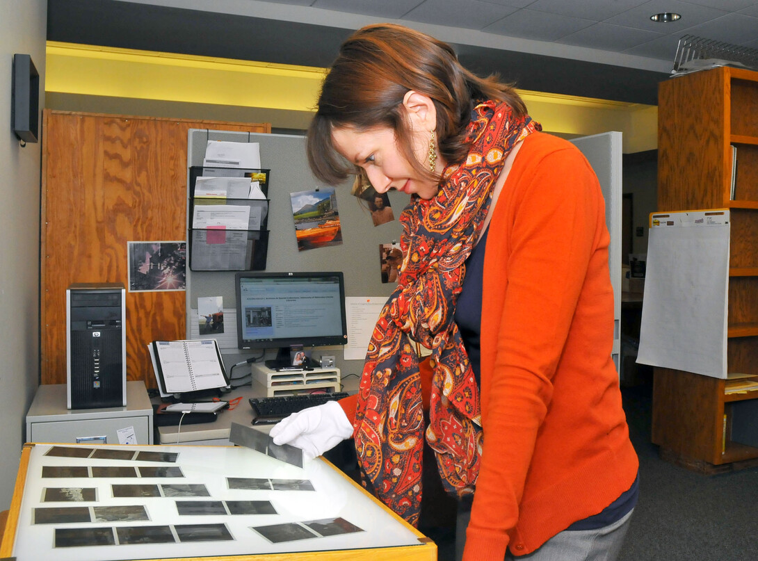 Traci Robison, an archives associate with the University Libraries' Archives and Special Collections, searches film negatives for possible Historypin submissions. UNL has been a contributor to the online historical archive since 2012, posting more than 650 photos.