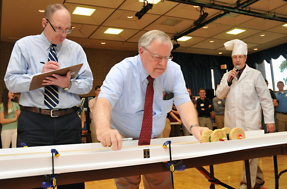 Race officials measure the distance covered by an entry in the 2012 Incredible, Edible Vehicle Competition. The annual engineering event is 2 to 4 p.m. Dec. 10 in the East Union.