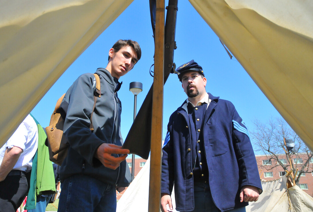 Braeden Perrie, a sophomore history and electrical engineering major from Minden, Neb., talks with Civil War re-enactor Joshua Andersen. The Shiloh Camp No. 2 division of the Sons of Union Veterans of the Civil War set up camp north of the Nebraska Union and interacted with students, faculty and staff on April 17.