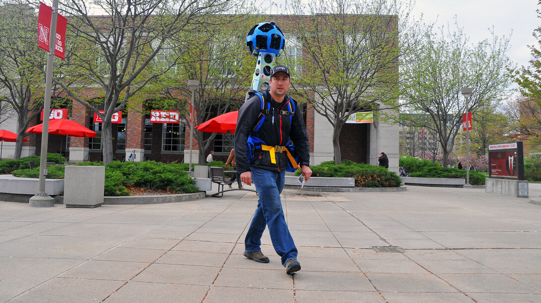 Lucas Marshall, a Google contractor, walks around the Nebraska Union plaza wearing the Google Trekker backpack.