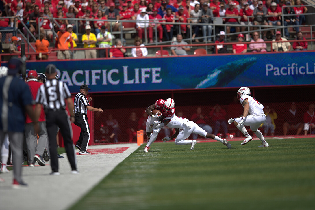 Dedrick Mills powers through a tackle along the sideline during the Huskers’ Aug. 31, 2019 game against South Alabama.