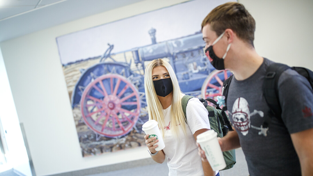 Students with coffee cups on East Campus