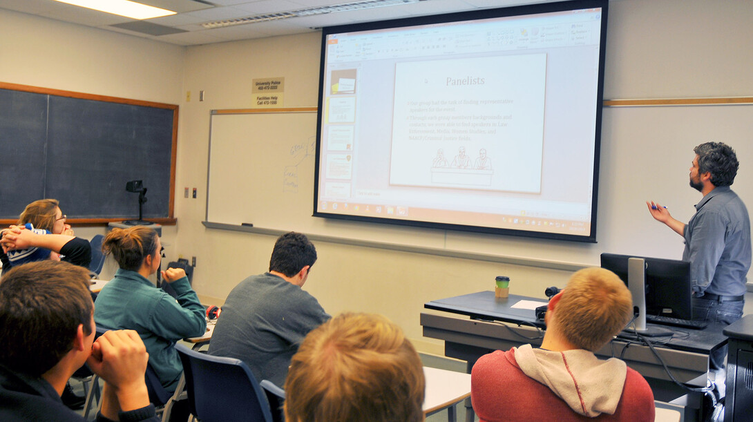 Joshua Ewalt (right) leads a classroom discussion in a "Small Group Communication" course.