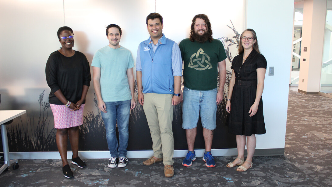 Carrie Heitman (right) stands with four program fellows.