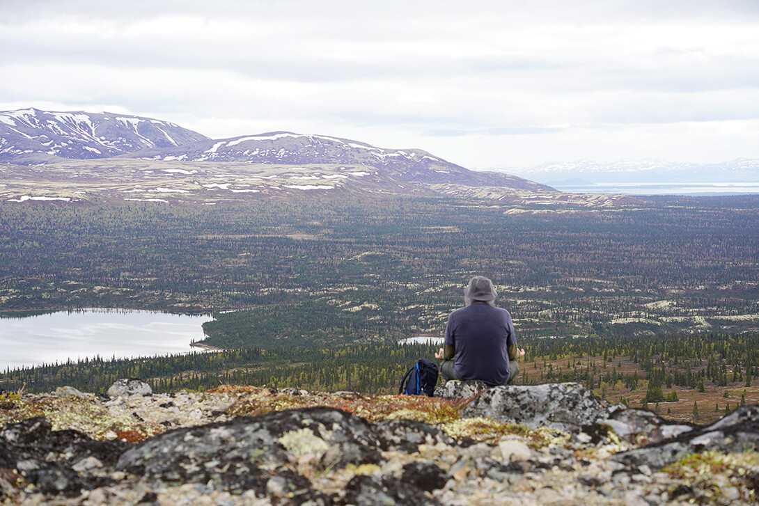 Frost takes in the scene of mountains in Alaska