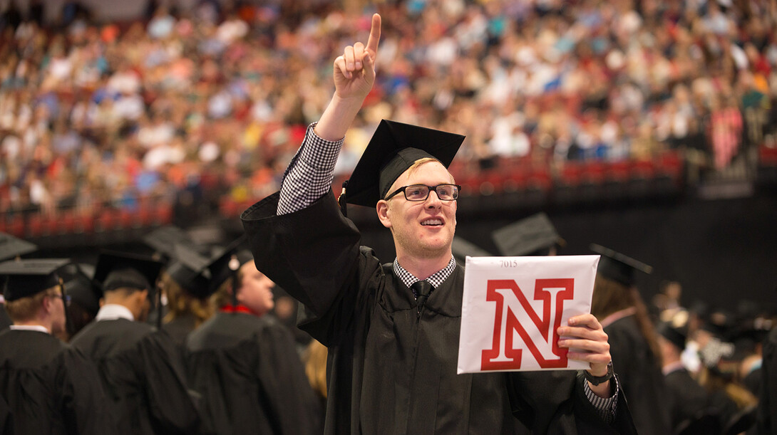 A student looks to family and friends after receiving his degree during the May 9 commencement ceremony in Pinnacle Bank Arena.