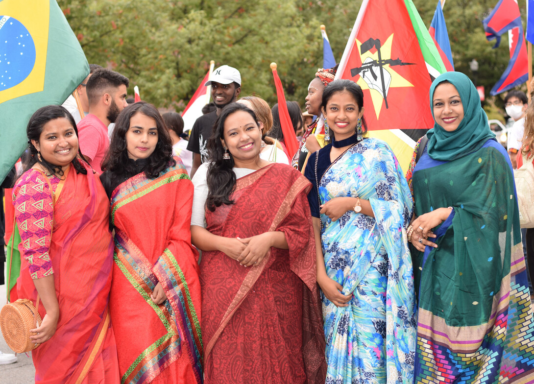 Students wearing traditional clothing from Bangladesh during the 2021 Homecoming Parade gather for a group photo. All students with traditional clothing from their country or heritage are invited to volunteer as models for the Mar. 26 Global Glam fashion show. 