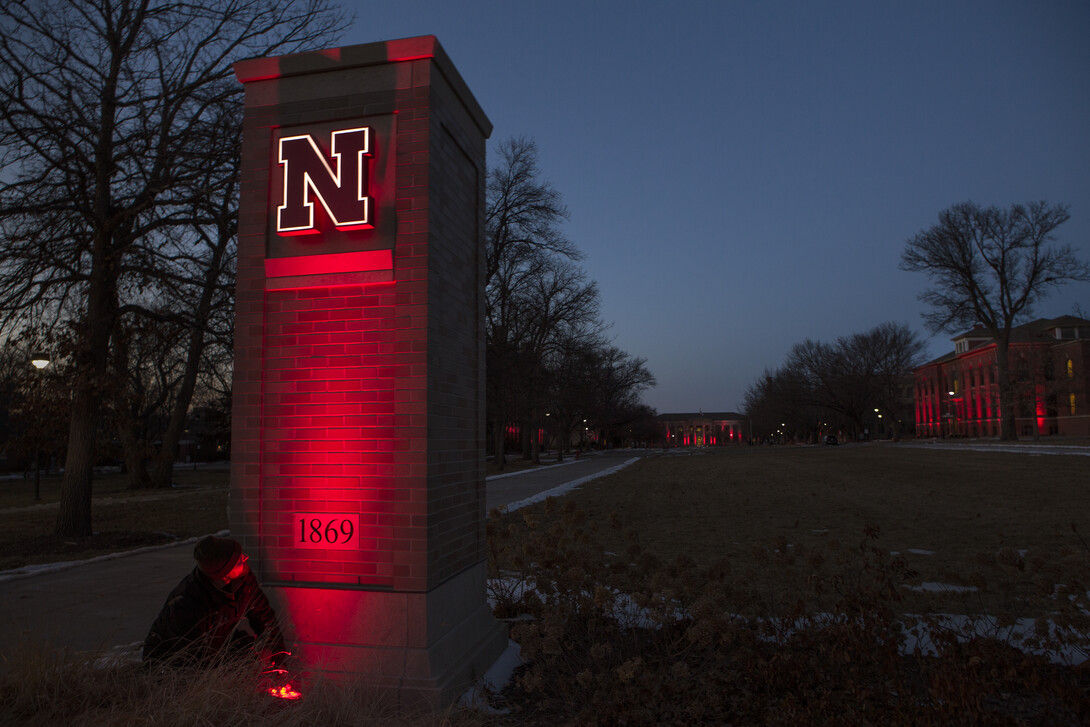 The gates to East Campus are flooded with red in honor of the 150th anniversary of the university charter.