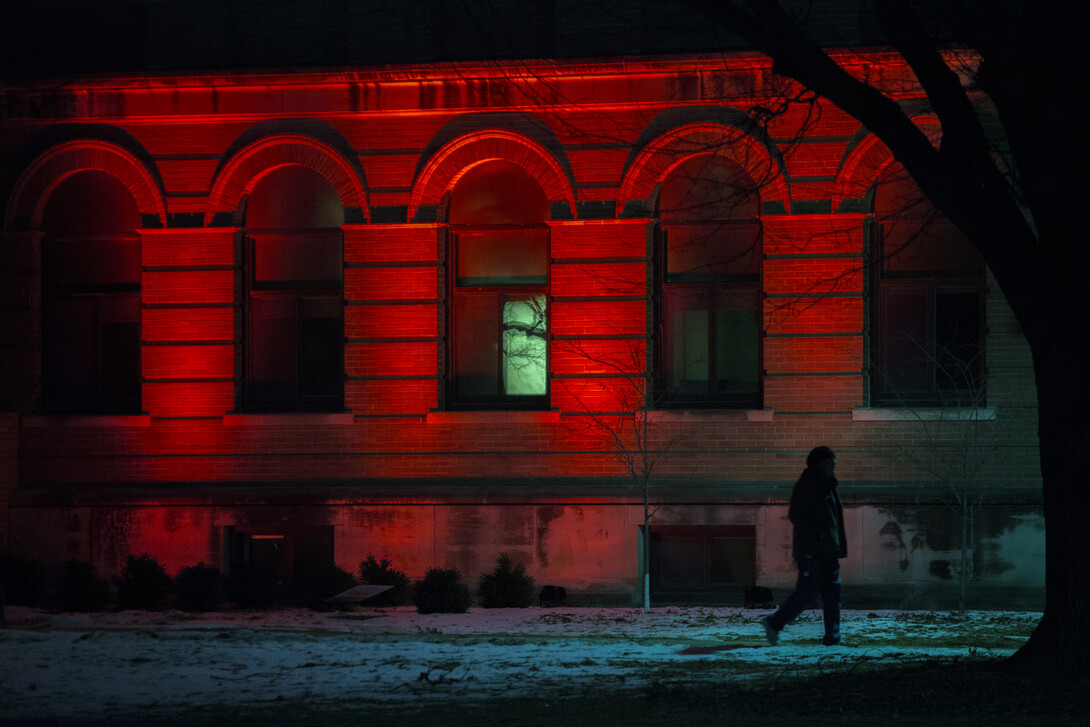 A student passes Entomology Hall on the East Campus Mall.