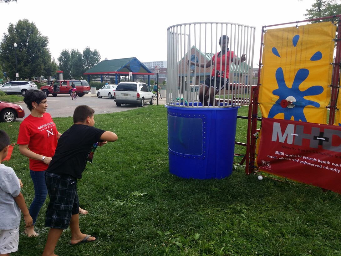 Bridget Goosby, associate professor of sociology and faculty member of the Minority Health Disparities Initiative, awaits a dunk in the tank during the Dunk the Doctor event at the Back to School Jam at Lincoln’s Malone Community Center Aug. 9. The Dunk the Doctor event is one of several community outreach activities MHDI is taking on to strengthen relationships among Nebraska communities and UNL researchers.