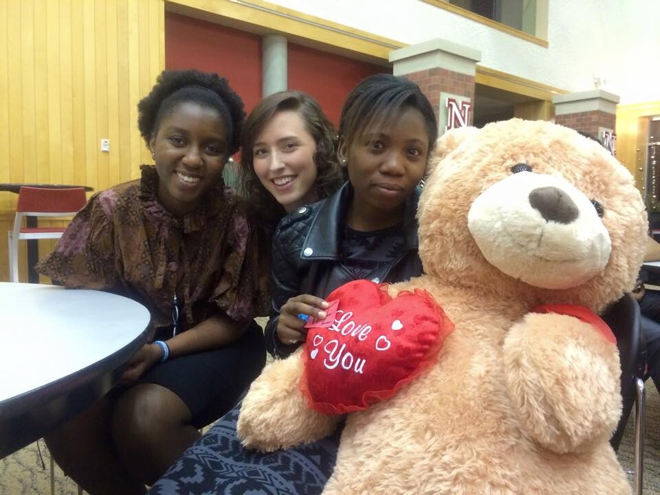 Grace Abraham (right) with a tedy bear given to her by classmates at Nebraska. 