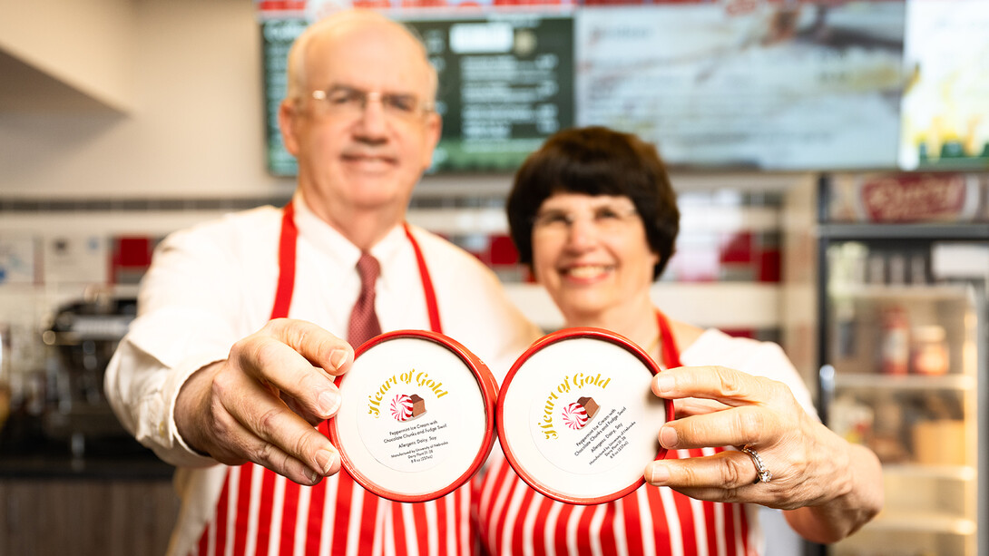 Jeffrey P. Gold and his wife, Robin Hayworth, hold pints of the new “Heart of Gold” ice cream available at the Dairy Store. 