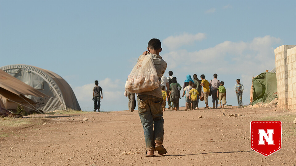 Child walking through refugee camp