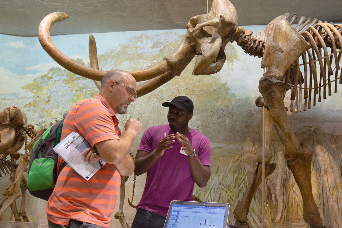 Oghenetega Allen Obewhere speaks with an LPS teacher in Morrill Hall