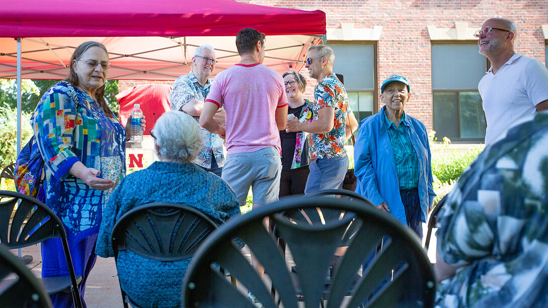 Attendees chat before the unveiling of a historical marker for Louis Crompton