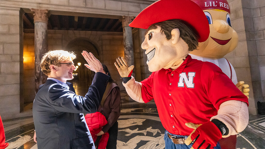 Herbie high-fiving student at Nebraska capitol