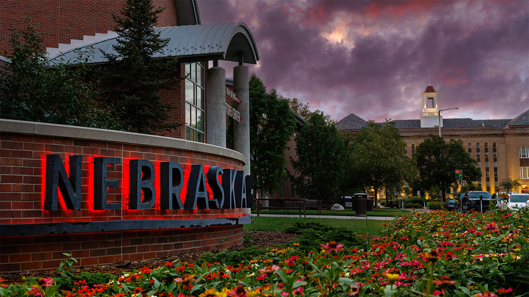 A purple and red sky over Love Library and the Van Brunt Visitors Center