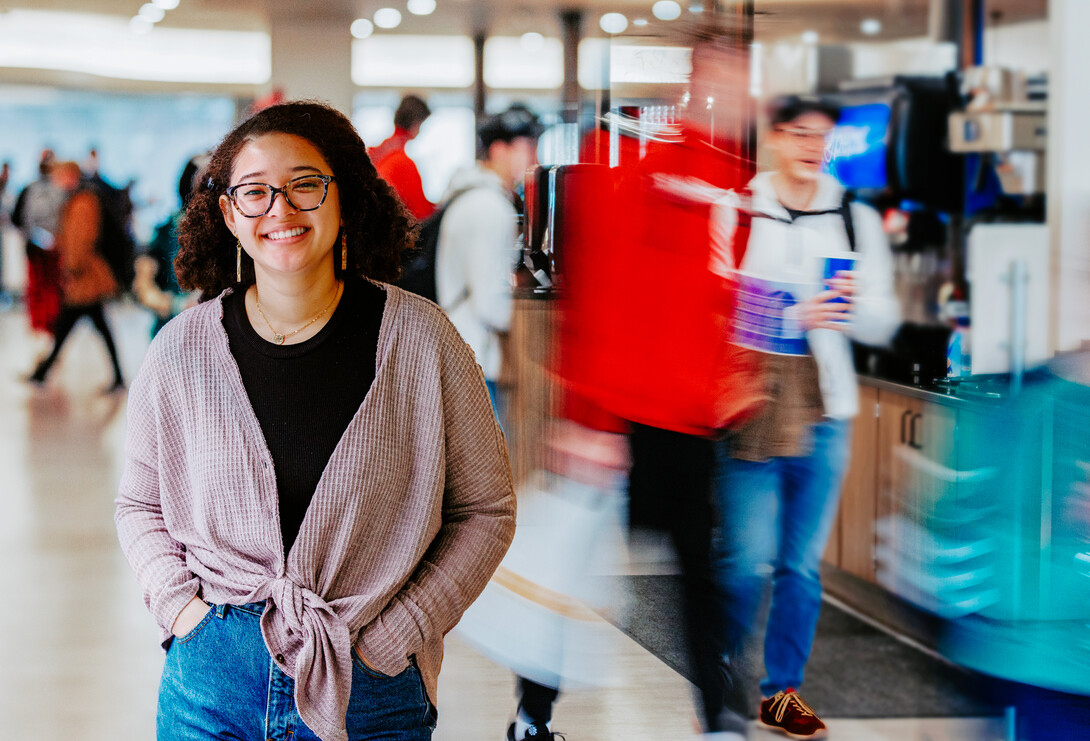 Maya stands in front of the lunch crowd at Selleck Dining Hall,