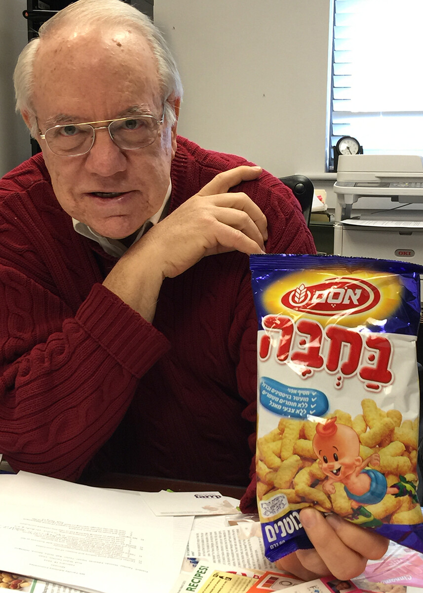 UNL's Stephen Taylor holds a bag of snacks that contain peanuts. Taylor said a new British study will change the way parents feed infants and how food-processing companies address food allergy issues.