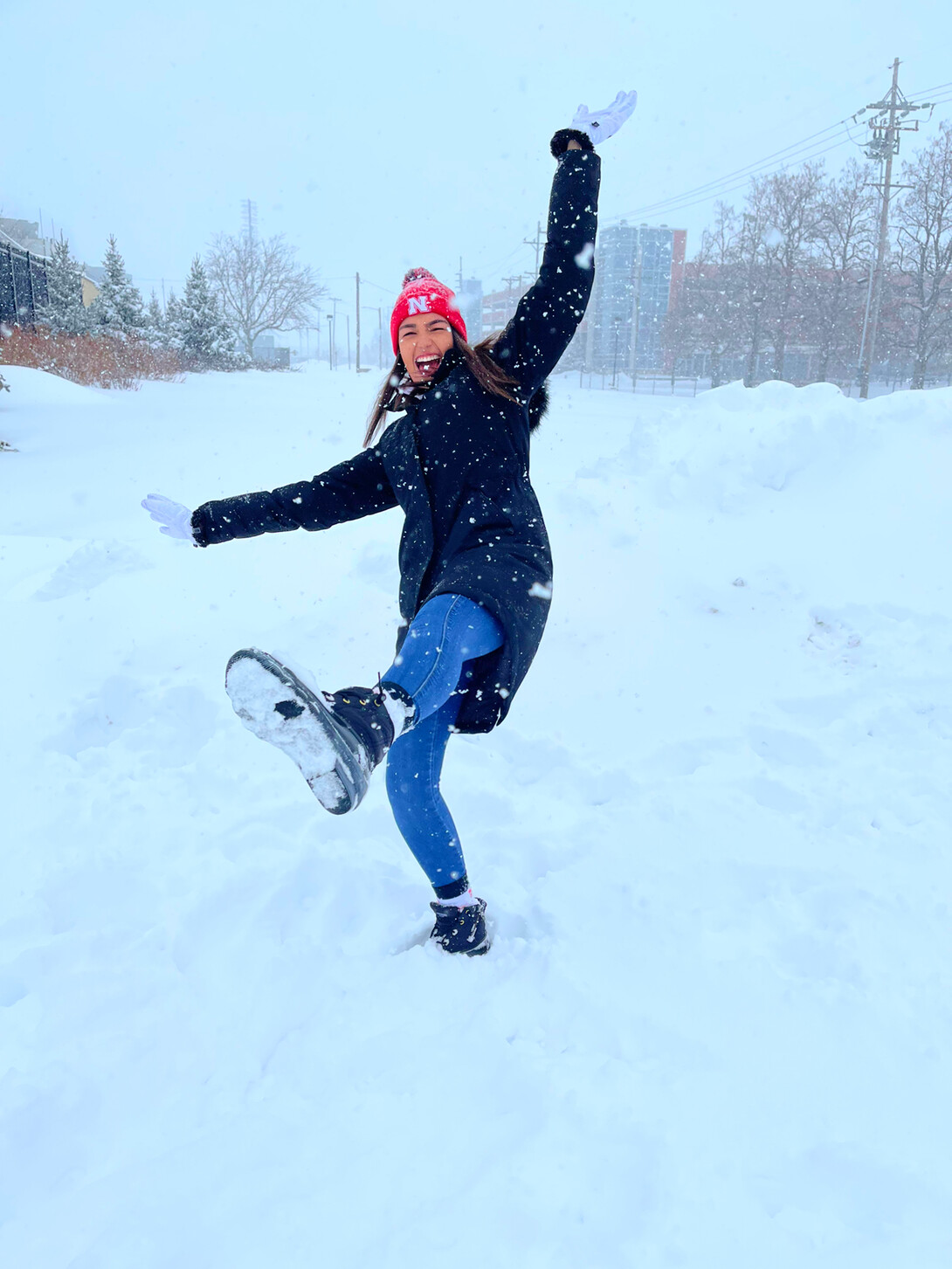 Anastasia Spruce plays in the snow on campus.