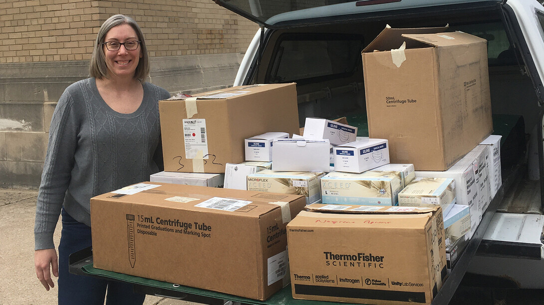 Rebecca Wachs, assistant professor of biological systems engineering, stands next to the medical supplies collected through a campus lab donation drive. The supplies were given to Bryan Health in Lincoln to assist with the response to COVID-19.