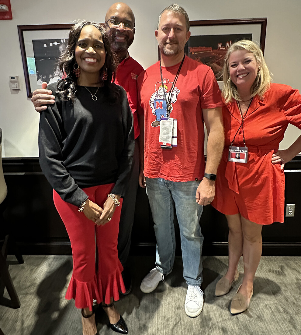 Tyler Madison (third from left), a middle school teacher from Grand Island, stands with (from left) Temple Bennett, Chancellor Rodney D. Bennett, and Jessie Herrmann in a Memorial Stadium suite. Madison was selected as a Chancellor’s Champion and attended the Northern Iowa game on Sept. 14.