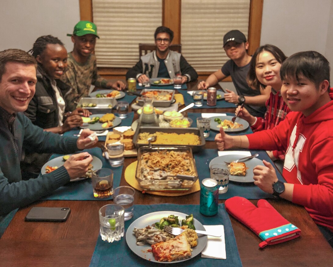 International students from four different countries were enjoying dinner at a faculty's home. 