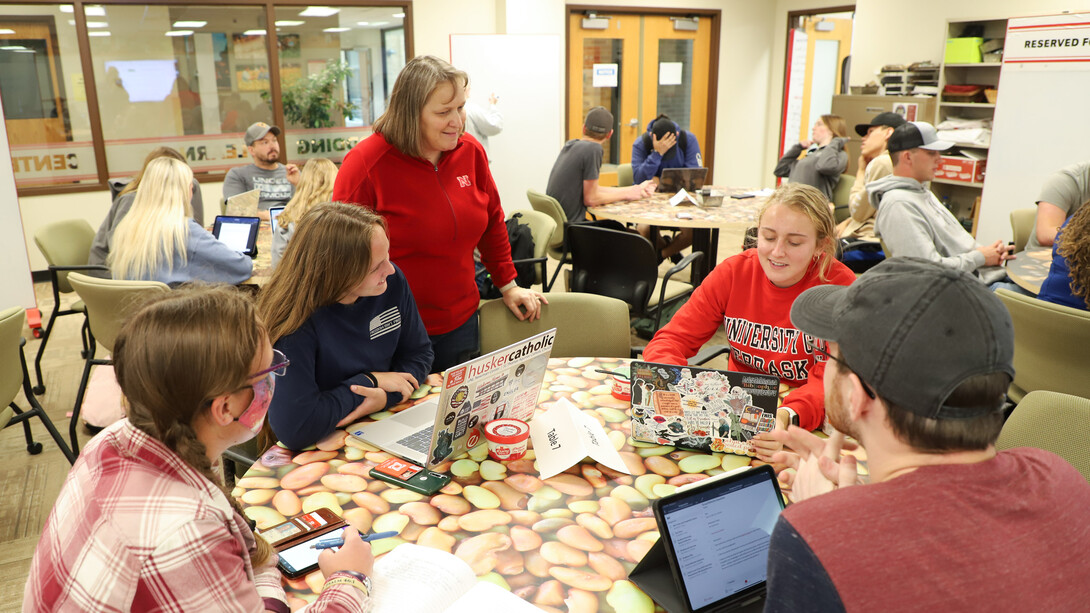 Anne Streich, center, professor of practice and lead instructor for PLAS 95 Plant and Landscape Systems Seminar class, talks with students about their interviews with an alumnus.