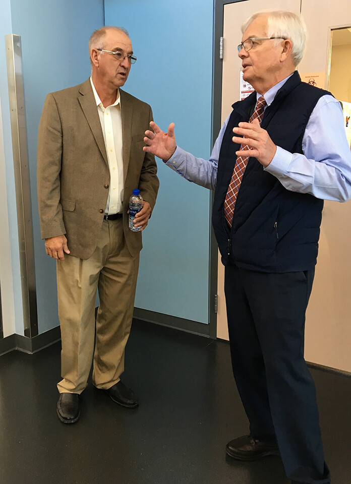 Myron Dorn (left) listens as Nebraska’s Clayton Kelling discusses the veterinary diagnostic center. Kelling is associate dean of agricultural sciences and natural resources, and director of the School of Veterinary Medicine and Biomedical Sciences.