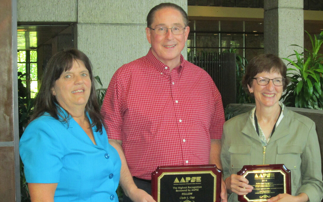 Nebraska’s Clyde Ogg (center) and Jan Hygnstrom (right) received national awards from the American Association of Pesticide Safety Educators. Also pictured is Kerry Richards, president of the association.