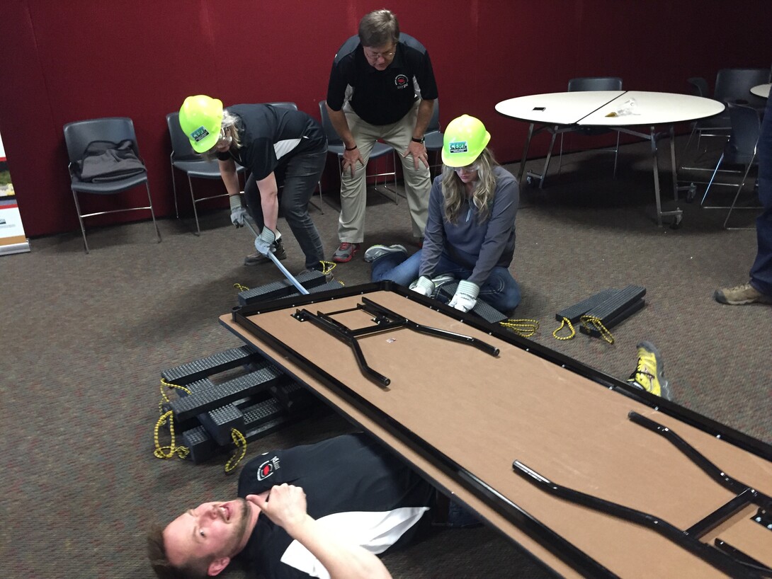 Instructors in the My Youth Preparedness Initiative Nebraska instructors practice cribbing, a technique that uses a temporary wooden structure to support heavy objects during construction, relocation, vehicle extrication and urban search and rescue.