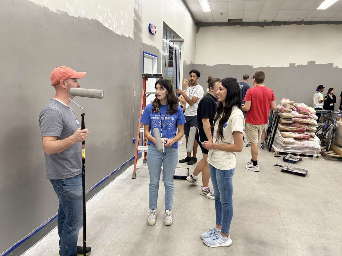 Nebraska law students pause for a quick talk during their service-learning experience at the Habitat for Humanity of Lincoln ReStore.