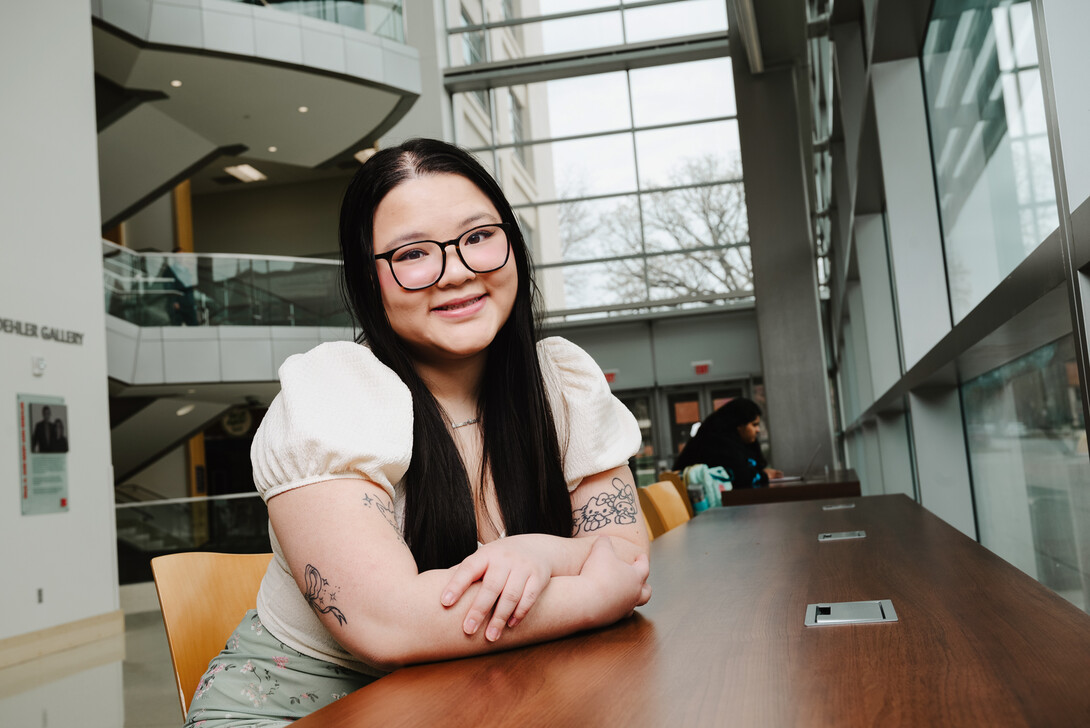 Photo by Murengezi Atali Benimana // Ann Vu — a marketing major from La Vista, Nebraska and a student worker in the College of Business — poses for a photo in Howard L. Hawks Hall. 