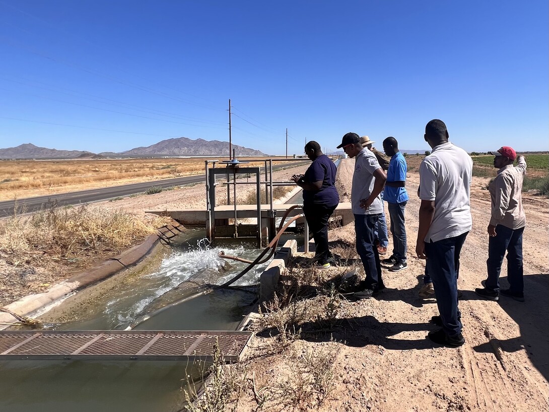 Students observe the water filter of an open canal in the Ak-Chin Indian Reservation, Arizona. 